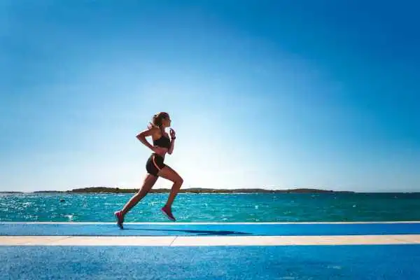 Woman running showing strong leg muscle Chesham